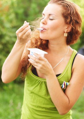 redhead girl eating yogurt