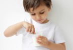little boy eating yogurt
