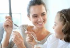 Mother-and-daughter-eating-yoghurt