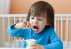 little boy eating yogurt