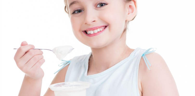 Girl eating a yogurt