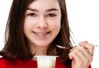 teenage girl eating yogurt