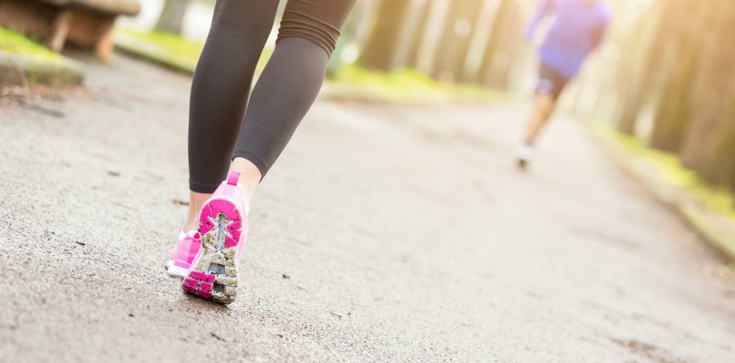 Female Runner Shoes closeup before Running at Park. Shallow depth of Field, focus on rear shoe