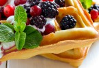 Breakfast with freshly baked belgian waffles with yogurt and berries